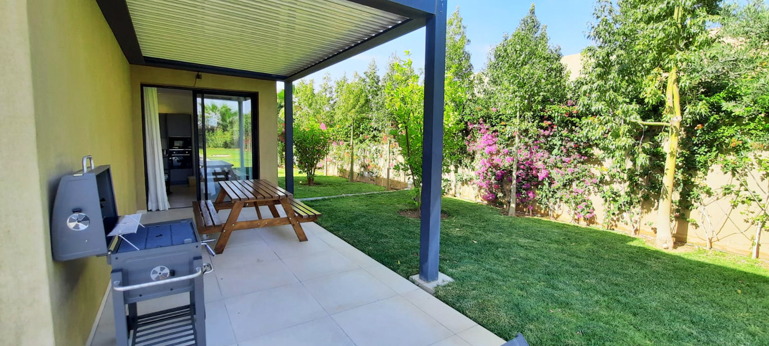 Pergola avec espace repas extérieur ouvert sur le jardin